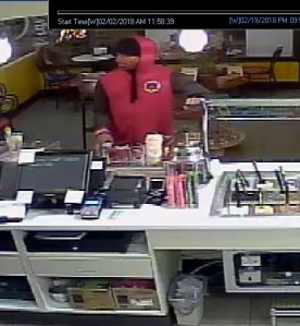 Subject in red hoodie at counter